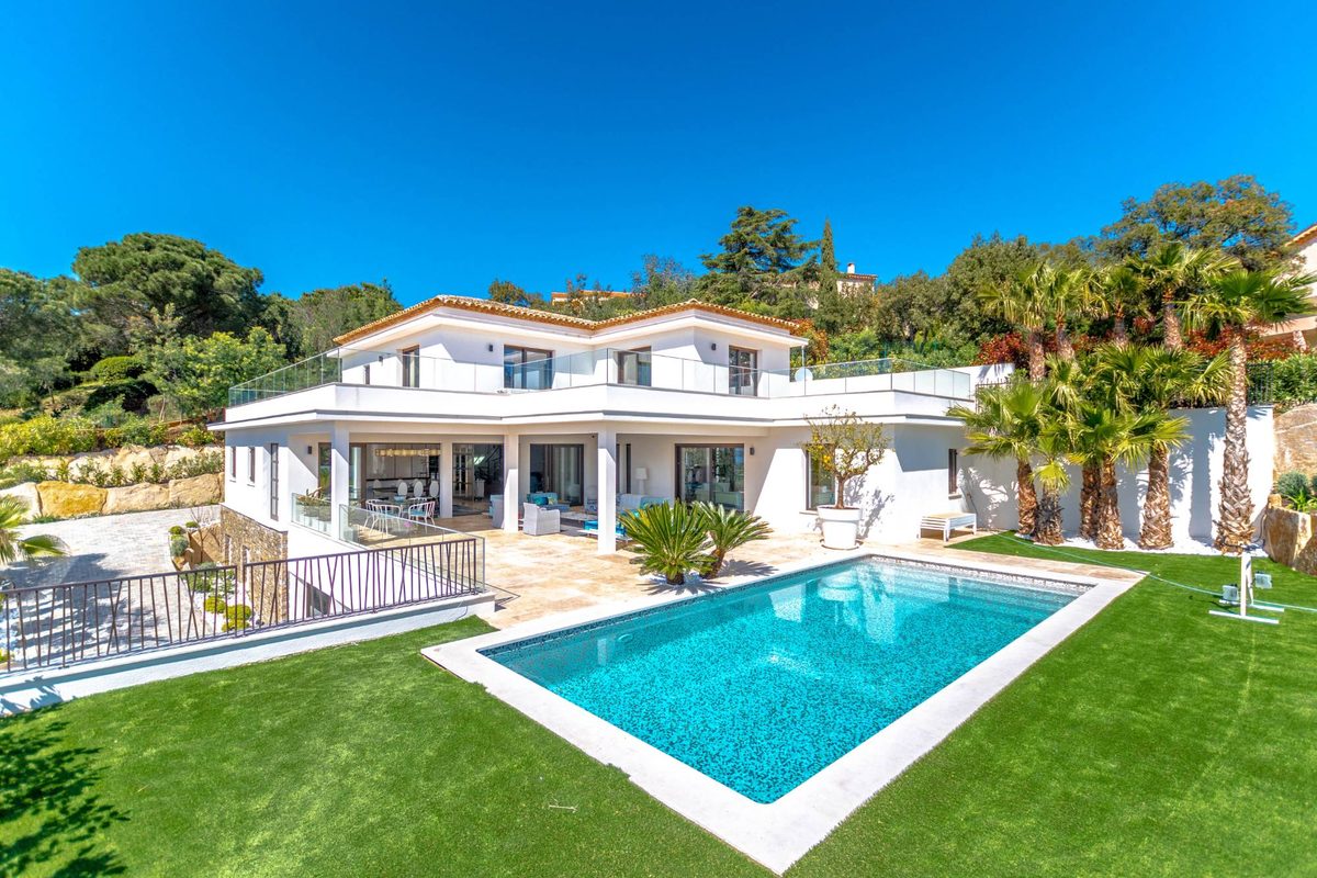 White flat-roofed villa and its pool